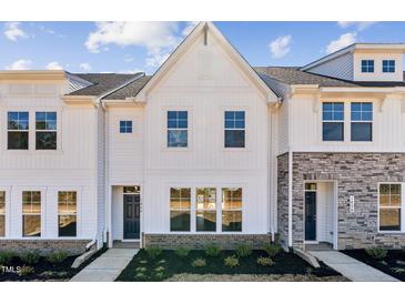 Charming new construction townhome with white siding and manicured landscaping at Lot 6 Cooper St, Sanford, NC 27330
