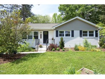 Charming single-story home with black shutters, landscaped front yard, and inviting entrance at 1004 Greenwich St, Raleigh, NC 27610