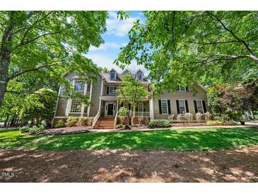 Charming two-story home with a landscaped front yard, brick steps and covered front porch at 101 Abbotsford Ct, Durham, NC 27712