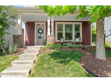 Inviting front entrance with a charming door wreath and well-maintained landscaping at 1016 Pemberly Ave, Morrisville, NC 27560