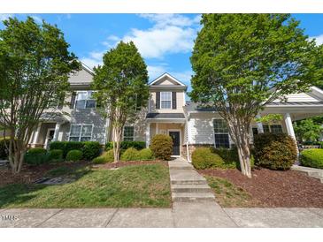 Charming townhouse with a manicured lawn and mature trees, offering curb appeal at 1204 Maroon Dr, Durham, NC 27713