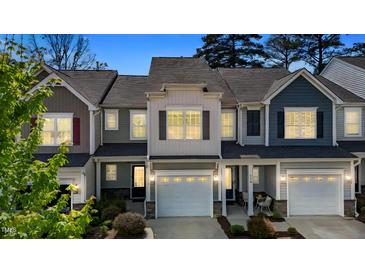 Charming townhome with a well-manicured lawn, attached garages, and inviting curb appeal at 124 Myatt Fern Dr, Garner, NC 27529