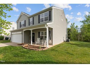 Charming two-story home with a welcoming front porch and well-manicured lawn at 1302 Ingle Ct, Burlington, NC 27215