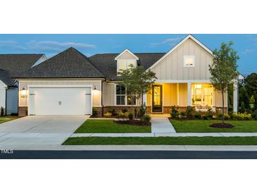 Charming single-Gathering home with a well-manicured lawn and attached garage at 1609 Garden Park Cir, Fuquay Varina, NC 27526