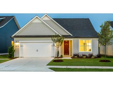 Charming single-Gathering home with a well-manicured lawn and inviting two-car garage at 1610 Garden Park Cir, Fuquay Varina, NC 27526