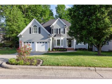 Charming two-story home with well-manicured lawn and mature trees at 216 Billingrath Turn Ln, Cary, NC 27519