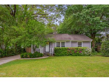 Charming single-story home featuring a well-manicured lawn and beautiful flower bushes at 2442 Stevens Rd, Raleigh, NC 27610