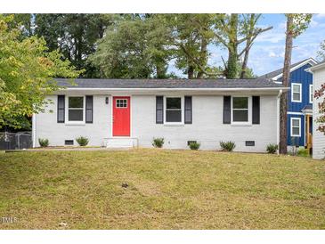 Charming single-story home with a freshly painted exterior and a vibrant red front door at 2612 Glenbrook Dr, Durham, NC 27704
