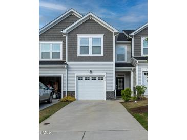 Charming two-story townhome with attached garage and neutral siding at 313 Kineton Woods Way Way, Garner, NC 27529