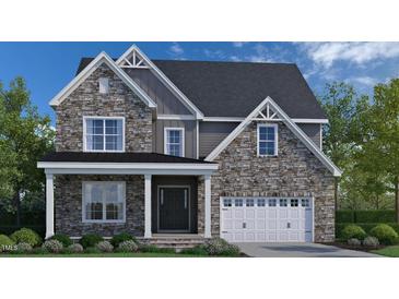 Charming two-story home with stone facade, gabled roof, and a welcoming front porch and attached two car garage at 3206 Armeria Dr, Apex, NC 27502