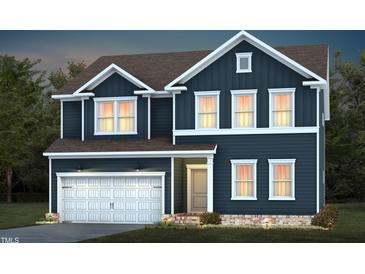 Two-story home featuring a dark blue exterior, attached garage, and well-maintained landscaping at 721 Denburn Pl, Raleigh, NC 27603