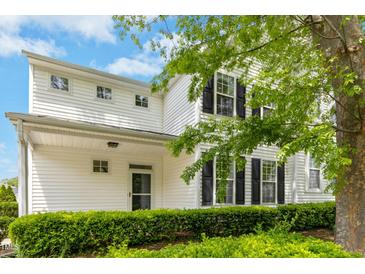 Inviting home showcasing manicured landscaping, a covered porch, and a classic white facade at 1121 Silky Dogwood Trl, Apex, NC 27502