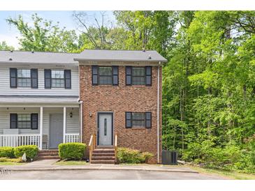 Charming brick townhouse with black shutters and a well-maintained front yard surrounded by lush trees at 1903 Malone Rd # E, Burlington, NC 27215
