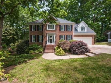 Beautiful brick two-story home with black shutters, landscaped front yard, and attached two-car garage at 204 Highlands Lake Dr. Dr, Cary, NC 27518