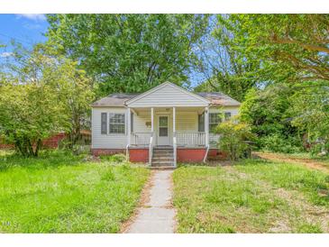 Modest single-story home featuring a small front porch and overgrown yard at 331 Highland Ave, Burlington, NC 27217