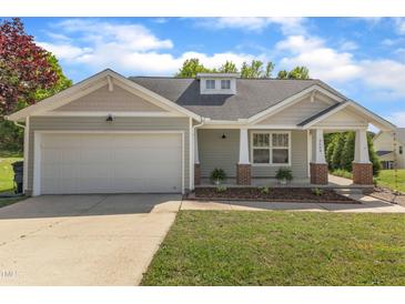 Charming single-story home with a two-car garage and a well-manicured lawn and covered porch at 3608 Deering Dr, Raleigh, NC 27616
