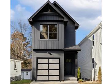 Modern two-story home with a single-car garage, gray siding, and black trim at 425 Longfellow St, Fuquay Varina, NC 27526