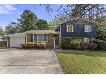 Charming two-story home with a brick facade and mature landscaping at 5713 Timber Ridge Dr, Raleigh, NC 27609