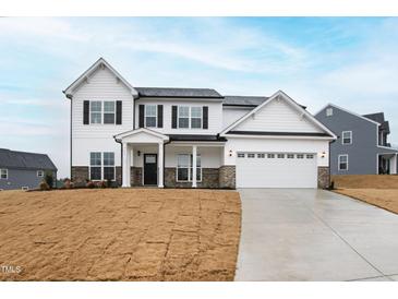 Inviting two-story home with a two-car garage, black shutters and a well-manicured lawn at 60 Rosewood Ln, Youngsville, NC 27596