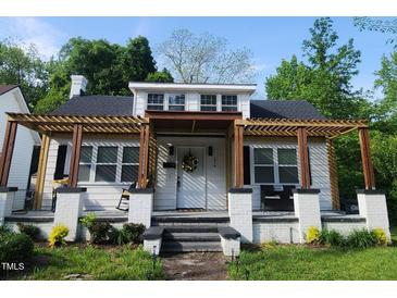 Charming renovated bungalow features a pergola-covered front porch and inviting curb appeal at 614 Henry St, Rocky Mount, NC 27803