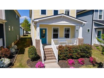 Charming two-story home with a welcoming front porch and colorful landscaping at 777 Fireball Ct, Knightdale, NC 27545