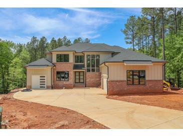 Stunning new construction home featuring a brick and siding exterior with a large driveway at 7805 Ailesbury Rd, Wake Forest, NC 27587