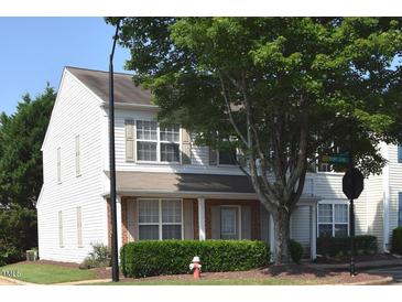 Charming two-story townhome with white siding, neutral shutters, well-maintained landscaping, and mature trees at 8511 Bright Loop, Raleigh, NC 27613