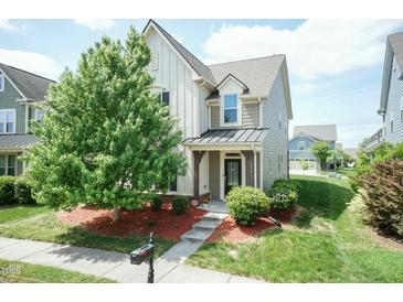 Charming two-story home with a well-manicured lawn and inviting front porch at 1013 Oatney Ridge Ln, Morrisville, NC 27560