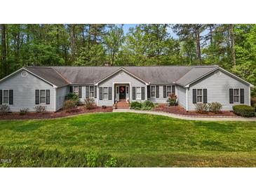 Charming single-story home with manicured front lawn and mature trees at 113 Denard St, Oxford, NC 27565