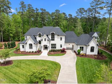 Stunning two-story white brick home featuring a lush green lawn and circular driveway at 1416 Bailey Hill Dr, Raleigh, NC 27614