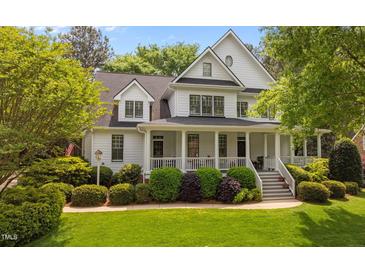 Charming two-story traditional home with a covered front porch and manicured landscaping at 1416 Heritage Links Dr, Wake Forest, NC 27587