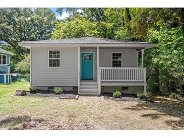 Charming single-story home with a welcoming front porch and a vibrant teal door at 2222 Oak Ridge Blvd, Durham, NC 27707
