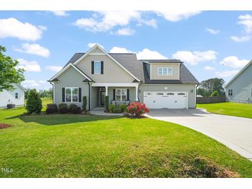 Charming home with a well-manicured lawn and inviting curb appeal at 60 Heart Pine Dr, Wendell, NC 27591