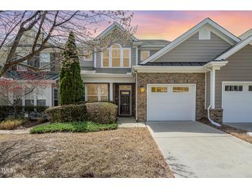 Charming brick and vinyl two-story home with well-maintained landscaping and attached two-car garage at 9207 Wooden Rd, Raleigh, NC 27617