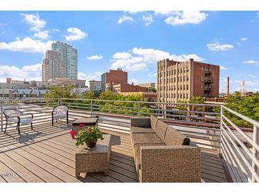 Relax on this rooftop deck with comfortable seating and a beautiful view of the city skyline at 101 Morris St # D, Durham, NC 27701