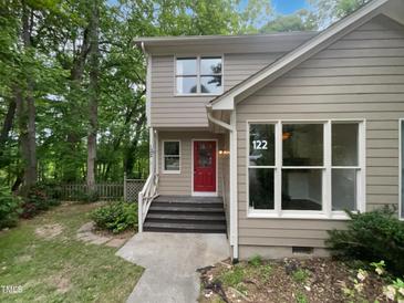 Charming two-story home with a inviting red front door and well maintained landscaping at 122 Mallard Ct, Chapel Hill, NC 27517