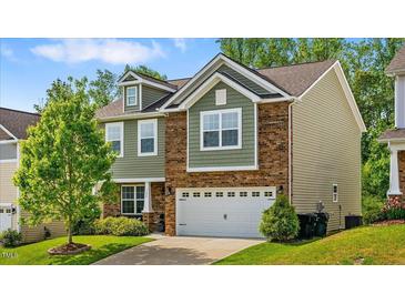 Charming two-story home featuring mixed brick and siding, a manicured lawn, and an attached two-car garage at 1287 Salters St, Burlington, NC 27215