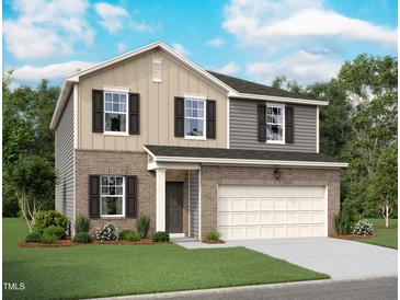 Two-story home features a brick and siding exterior, attached two-car garage, and professionally landscaped front yard at 141 Gladstone Loop, Clayton, NC 27520