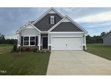 Charming two-story home with a manicured lawn and a two car garage at 202 E Victory View Ter, Smithfield, NC 27577