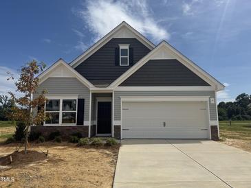 Charming single-Gathering home featuring two-car garage, stone accents, and craftsman style architecture at 202 E Victory View Ter, Smithfield, NC 27577