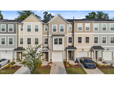 Attractive townhomes in neutral colors featuring attached garages and well maintained landscaping at 2617 Chert Ln, Raleigh, NC 27610