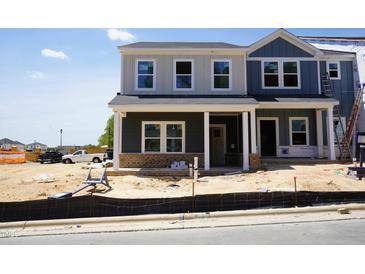 Two-story new construction home featuring mixed-material facade and covered front porch at 3714 Rosebush Dr, Zebulon, NC 27597