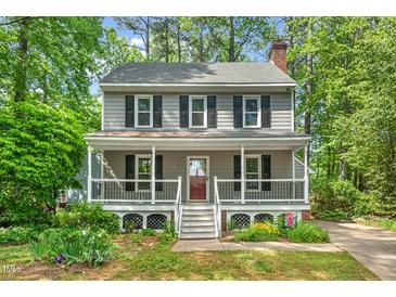 Charming two-story home with a welcoming front porch and mature landscaping at 4420 Tetbury Pl, Raleigh, NC 27613