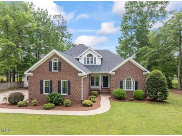 Charming brick home featuring mature landscaping, green lawn and neutral colors at 4612 River Farm Rd, Rocky Mount, NC 27803