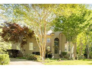 Charming home featuring a well-manicured lawn and mature trees providing ample shade and curb appeal at 5129 Bartons Enclave Ln, Raleigh, NC 27613