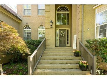 Inviting front entrance with detailed brickwork, wooden door and decorative wreath at 5129 Bartons Enclave Ln, Raleigh, NC 27613