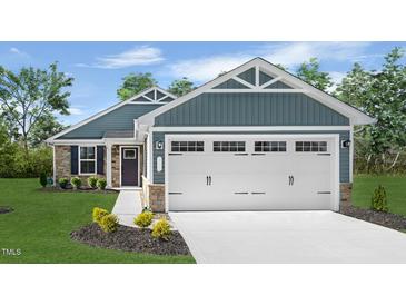 Charming single-story home with a two-car garage, well-manicured lawn, and appealing curb appeal at 70 Saintsbury Dr, Fuquay Varina, NC 27526