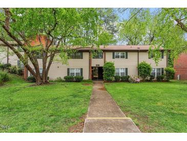 Inviting townhouse with well-maintained lawn, lush trees, and charming curb appeal in a desirable location at 1217 Manassas Ct # H, Raleigh, NC 27615