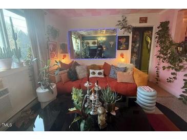 Inviting living room filled with plants, a plush sofa, and unique decor create a cozy atmosphere at 124 Fidelity St # Apt 27, Carrboro, NC 27510