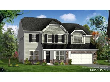 Charming two-story home featuring gray siding, black shutters, stone accents, and a two-car garage at 149 Whimbrel Ct, Lillington, NC 27546